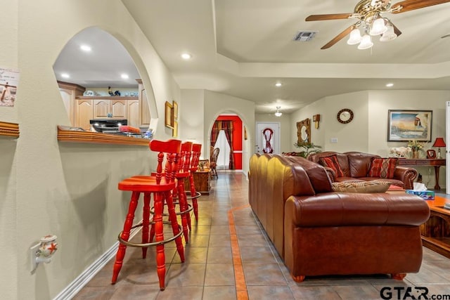 841 Pops Landing Rd, Ore City, TX 75683 - living area with arched walkways, ceiling fan, recessed lighting, a raised ceiling, and light tile patterned floors