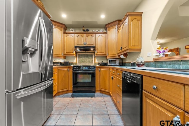 841 Pops Landing Rd, Ore City, TX 75683 - kitchen with black appliances, under cabinet range hood, light tile patterned floors, recessed lighting, and arched walkways