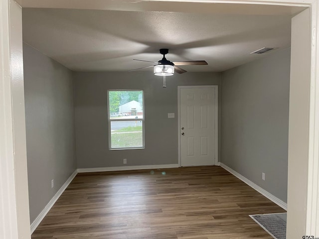 empty room featuring wood-type flooring and ceiling fan