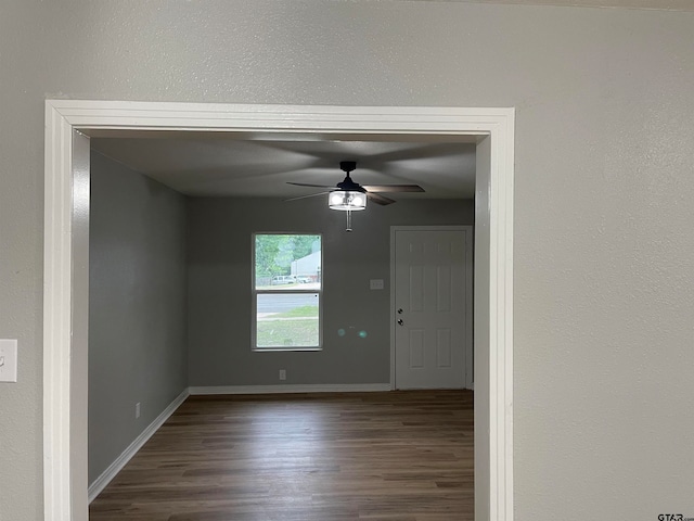 spare room with ceiling fan and dark hardwood / wood-style floors