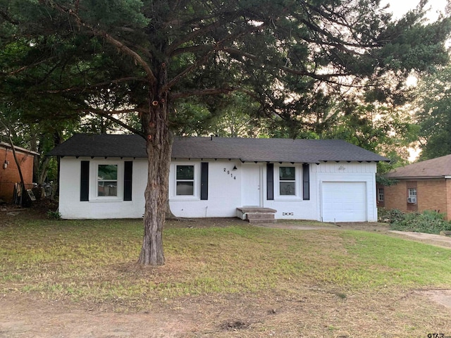 ranch-style house with a front lawn and a garage