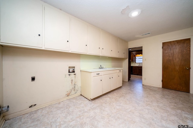 washroom featuring cabinet space, washer hookup, electric dryer hookup, baseboards, and light floors