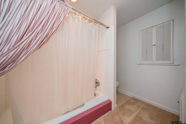 bathroom with toilet, shower / bath combo with shower curtain, and baseboards