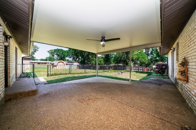 view of patio with fence and a ceiling fan