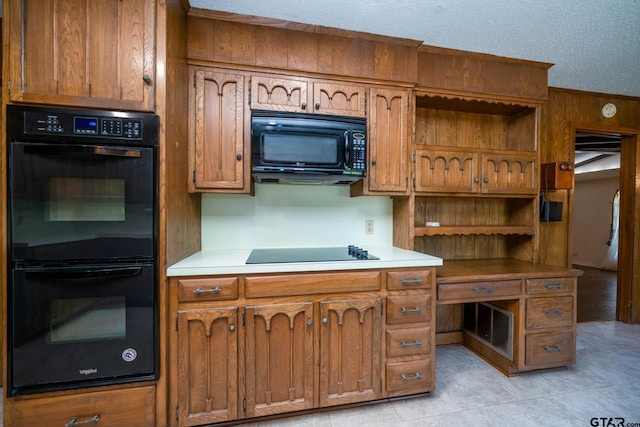 kitchen featuring black appliances, open shelves, brown cabinetry, and light countertops