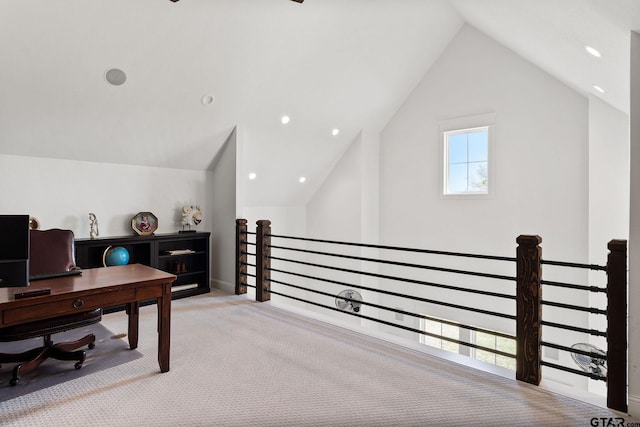 carpeted office space featuring lofted ceiling