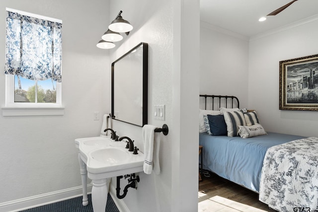 bathroom with ceiling fan, hardwood / wood-style floors, dual sinks, and ornamental molding