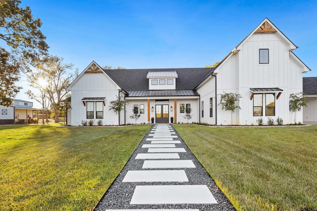 modern farmhouse style home with a front lawn