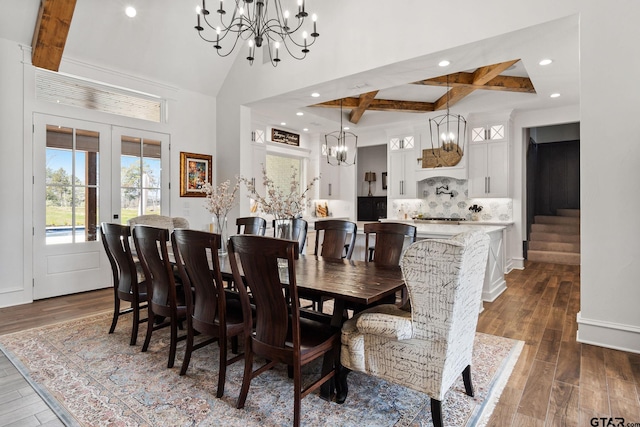 dining space with beamed ceiling, dark hardwood / wood-style flooring, a high ceiling, and french doors