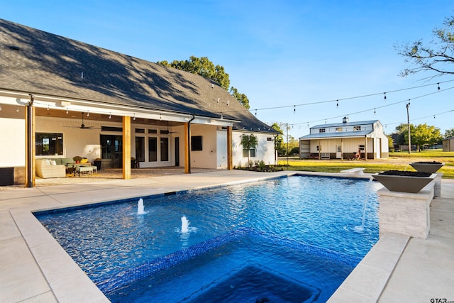 view of pool with an outdoor living space, a hot tub, ceiling fan, and a patio area