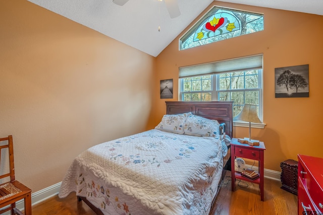 bedroom featuring ceiling fan, hardwood / wood-style flooring, and lofted ceiling