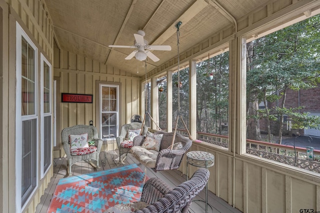 sunroom with ceiling fan, wood ceiling, and vaulted ceiling