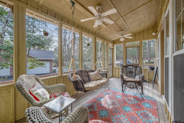 sunroom featuring ceiling fan and wood ceiling