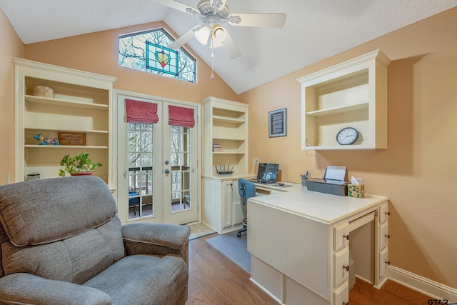 office featuring french doors, ceiling fan, vaulted ceiling, and light hardwood / wood-style flooring