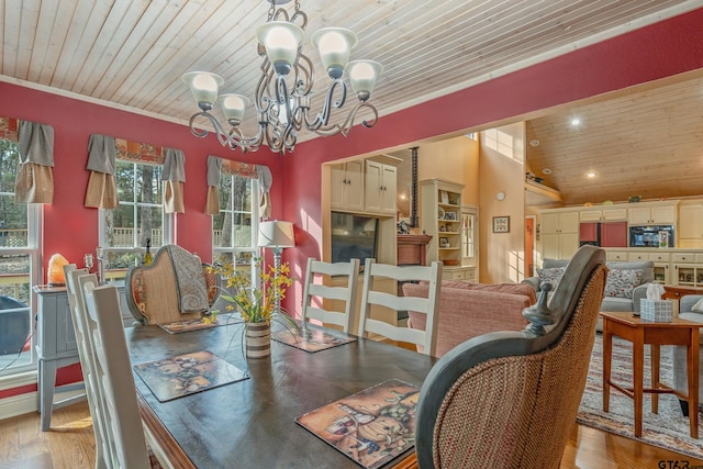 dining area featuring hardwood / wood-style flooring, a notable chandelier, crown molding, and wood ceiling