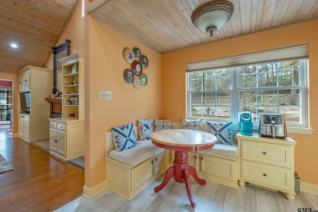 dining area featuring wooden ceiling, breakfast area, and light wood-type flooring