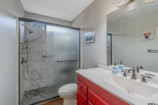 bathroom featuring an enclosed shower, vanity, wood-type flooring, and toilet