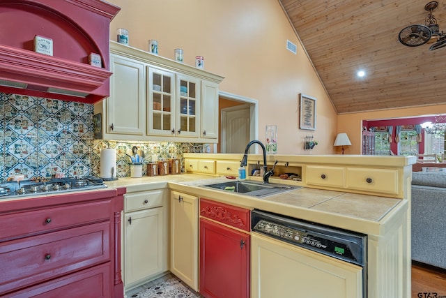 kitchen with backsplash, custom exhaust hood, sink, paneled dishwasher, and cream cabinets