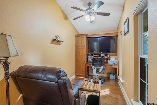 living room with ceiling fan, light wood-type flooring, and vaulted ceiling