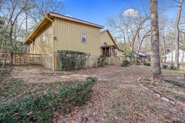 view of property exterior with a wooden deck