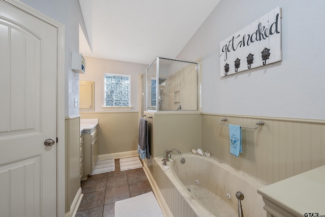 bathroom featuring wooden walls, plus walk in shower, lofted ceiling, tile patterned floors, and vanity