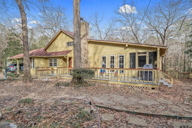 rear view of house with a wooden deck