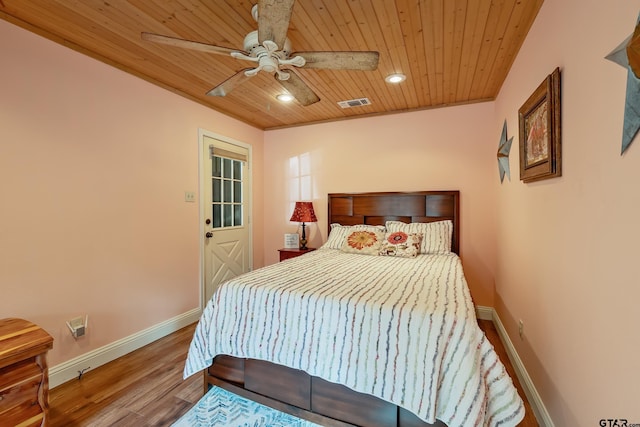 bedroom with ceiling fan, hardwood / wood-style floors, ornamental molding, and wood ceiling