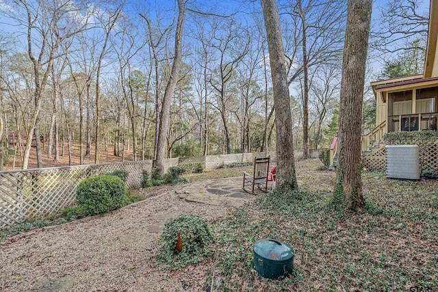 view of yard featuring central AC and a patio area