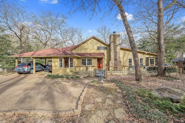 490 Branding Iron, Holly Lake Ranch, TX 75765 - view of front of home with a chimney, driveway, and an attached carport