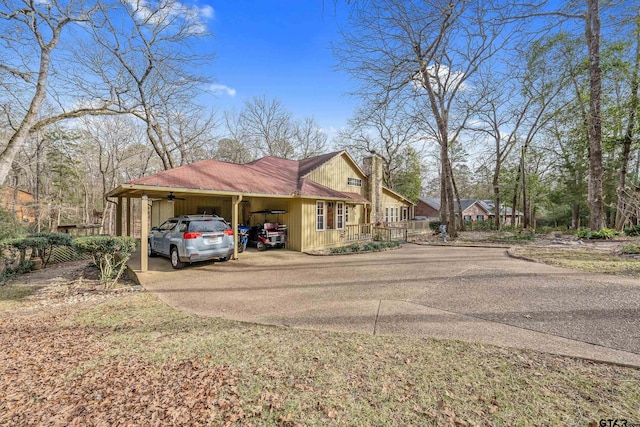 view of side of home with a carport