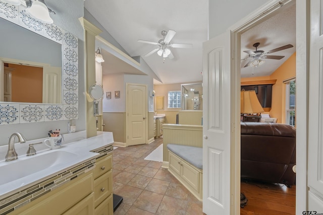 bathroom featuring vaulted ceiling, ceiling fan, tile patterned floors, and vanity