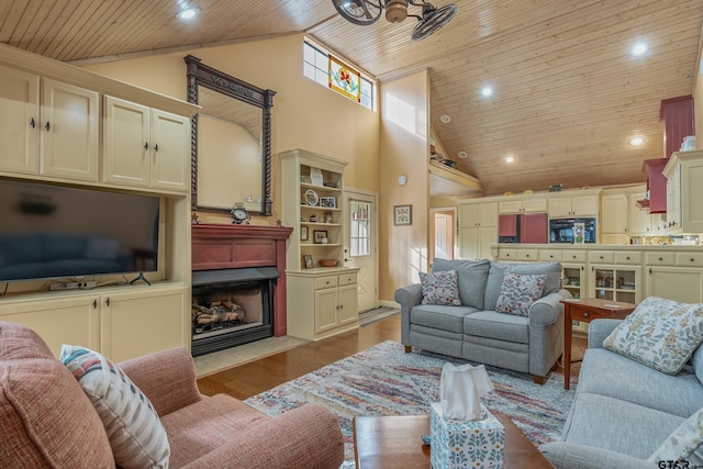 living room featuring ceiling fan, wood ceiling, light hardwood / wood-style floors, and high vaulted ceiling