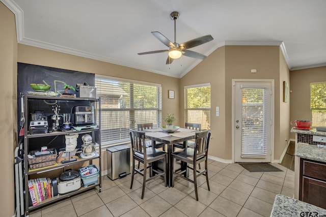 dining space featuring lofted ceiling, plenty of natural light, light tile patterned floors, and ornamental molding