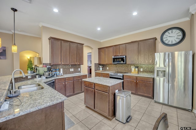 kitchen featuring sink, light tile patterned floors, decorative light fixtures, kitchen peninsula, and stainless steel appliances