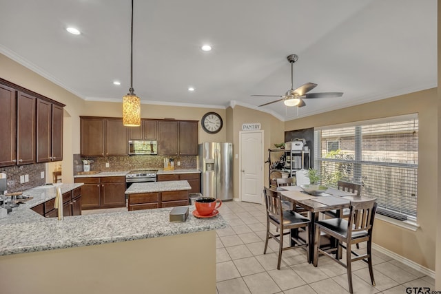 kitchen with ceiling fan, light stone countertops, crown molding, and appliances with stainless steel finishes