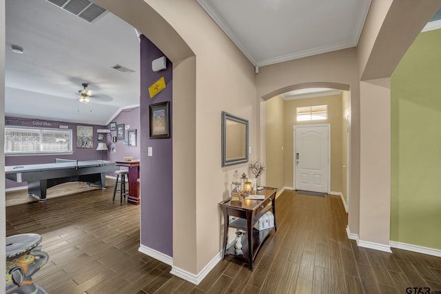 entryway featuring ceiling fan, a healthy amount of sunlight, and ornamental molding