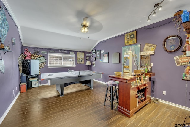 recreation room with ceiling fan, ornamental molding, and vaulted ceiling