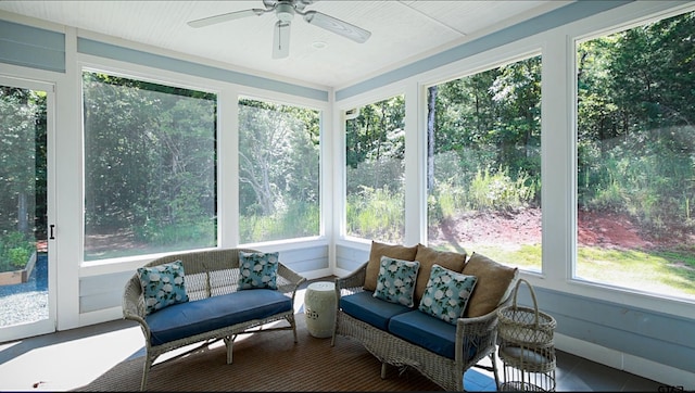 sunroom / solarium with a healthy amount of sunlight and ceiling fan