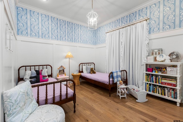 bedroom with a chandelier, hardwood / wood-style flooring, and ornamental molding