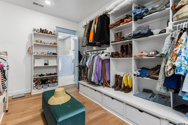 walk in closet featuring light hardwood / wood-style floors