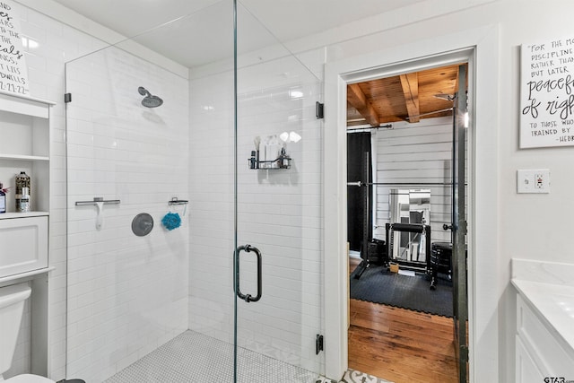 bathroom featuring toilet, an enclosed shower, wood ceiling, and hardwood / wood-style flooring