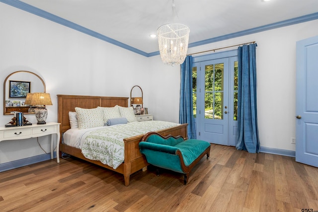 bedroom with ornamental molding, light hardwood / wood-style floors, and a chandelier