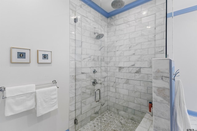 bathroom with a shower with door