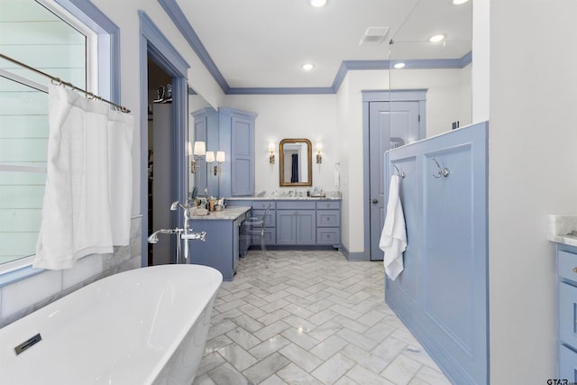 bathroom featuring crown molding, plenty of natural light, vanity, and a tub