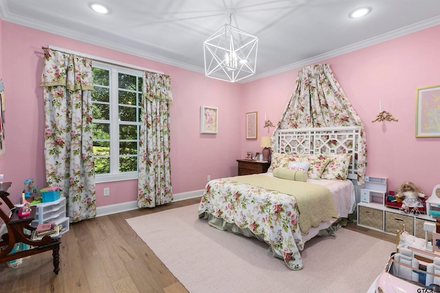 bedroom with hardwood / wood-style floors, a notable chandelier, and crown molding