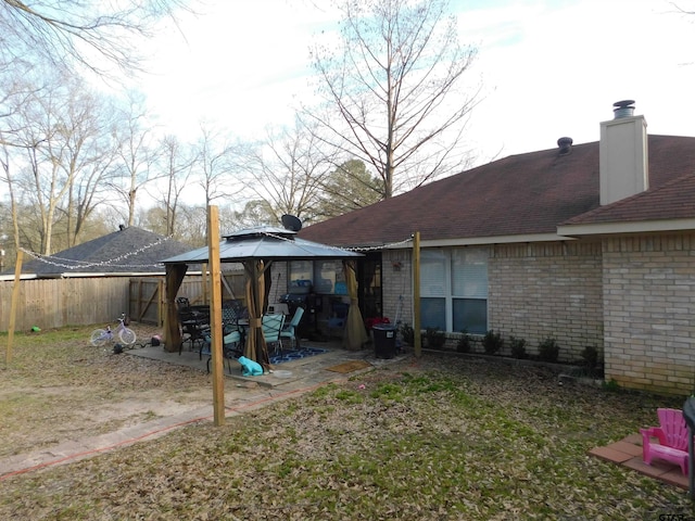 view of yard featuring a gazebo, a patio area, and fence