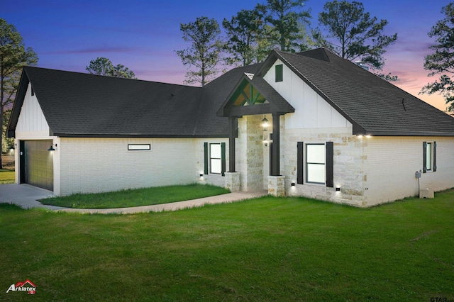 modern farmhouse with a garage and a lawn