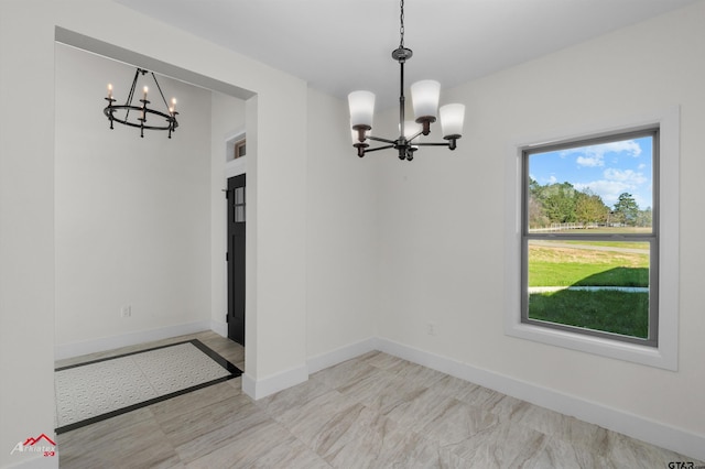 unfurnished dining area with plenty of natural light and a notable chandelier