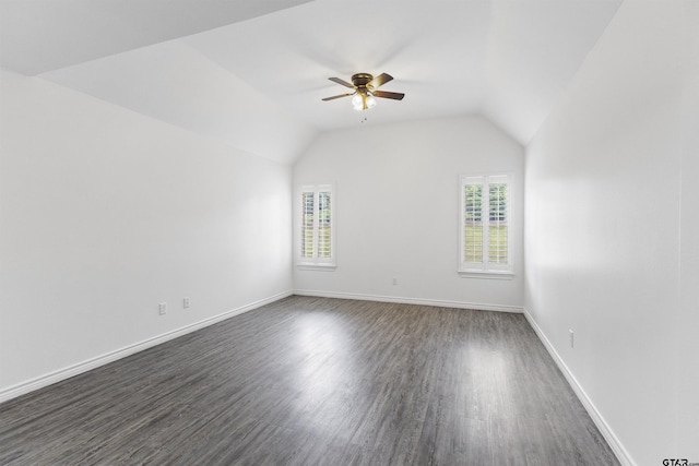 additional living space with a ceiling fan, dark wood-style flooring, baseboards, and vaulted ceiling