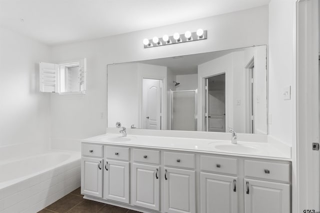 full bathroom with a sink, a shower stall, tile patterned floors, a garden tub, and double vanity
